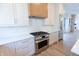 Modern kitchen with stainless steel appliances and white cabinets at 2133 N Talbott St, Indianapolis, IN 46202