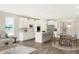 Open concept kitchen and dining area with hardwood floors and white cabinetry at 9911 Palermo Ave, Indianapolis, IN 46239