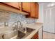 Modern kitchen sink with updated faucet and tile backsplash at 3965 N Meridian St # Apt 2G, Indianapolis, IN 46208