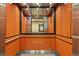 Clean and modern elevator with wood-like paneling at 3965 N Meridian St # Apt 2G, Indianapolis, IN 46208