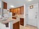 Efficient galley kitchen with wood cabinets and tile backsplash at 3965 N Meridian St # Apt 2G, Indianapolis, IN 46208