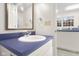 Simple bathroom with vanity, sink, and view of laundry room at 3531 Shoshonee Dr, Columbus, IN 47203