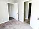Bedroom with gray walls, carpeted floors, and access to other rooms at 3106 Newton Ave, Indianapolis, IN 46201