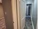 Hallway with gray walls, wood-look floors, and doors to bedrooms and bath at 3106 Newton Ave, Indianapolis, IN 46201
