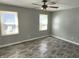 Bedroom with gray walls, wood-look floors, and ceiling fan at 3106 Newton Ave, Indianapolis, IN 46201