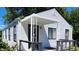White house with black accents, covered porch, and deck at 3106 Newton Ave, Indianapolis, IN 46201