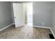 Bedroom with gray walls, carpeted floors, and door to bathroom at 3106 Newton Ave, Indianapolis, IN 46201