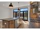 Modern kitchen with island, stainless steel appliances, and hardwood floors at 671 E 16Th St, Indianapolis, IN 46202