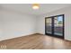 Spacious bedroom with hardwood floors and access to patio at 671 E 16Th St, Indianapolis, IN 46202