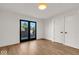 Spacious bedroom with hardwood floors and access to patio at 671 E 16Th St, Indianapolis, IN 46202