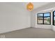 Spacious bedroom with large window, neutral walls, and carpeted floors at 671 E 16Th St, Indianapolis, IN 46202