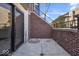 Private patio with brick wall and sliding glass door access at 671 E 16Th St, Indianapolis, IN 46202