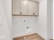 Laundry room with built-in cabinets and vinyl flooring at 671 E 16Th St, Indianapolis, IN 46202