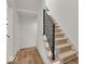Modern staircase with metal railing and carpeted steps at 671 E 16Th St, Indianapolis, IN 46202