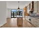 Modern kitchen with island, stainless steel appliances, and hardwood floors at 671 E 16Th St, Indianapolis, IN 46202