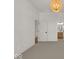 Bright bedroom with neutral walls, carpeted floors, and access to hallway at 671 E 16Th St, Indianapolis, IN 46202