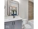 Modern bathroom with gray vanity, white countertop, and a bathtub at 673 E 16Th St, Indianapolis, IN 46202