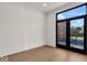 Cozy bedroom with hardwood floors and access to a private deck at 673 E 16Th St, Indianapolis, IN 46202