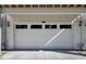 Attached garage with white door and three windows at 673 E 16Th St, Indianapolis, IN 46202