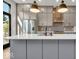 Sleek kitchen with gray cabinetry, quartz countertops and island at 673 E 16Th St, Indianapolis, IN 46202