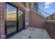 Private patio with brick wall and sliding glass doors at 673 E 16Th St, Indianapolis, IN 46202