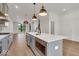 Open concept kitchen with island, stainless steel appliances, and hardwood floors at 673 E 16Th St, Indianapolis, IN 46202