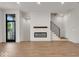 Bright living room with hardwood floors, fireplace, and modern staircase at 673 E 16Th St, Indianapolis, IN 46202
