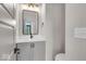 Modern bathroom with gray vanity, frameless mirror, and updated fixtures at 673 E 16Th St, Indianapolis, IN 46202