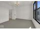 Spacious bedroom with a large window and access to a hallway at 675 E 16Th St, Indianapolis, IN 46202