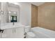 Modern bathroom with white vanity, bathtub, and updated fixtures at 675 E 16Th St, Indianapolis, IN 46202