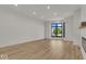 Bright living room featuring hardwood floors and a large window at 675 E 16Th St, Indianapolis, IN 46202