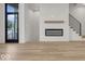 Modern living room with fireplace, hardwood floors, and large windows at 675 E 16Th St, Indianapolis, IN 46202