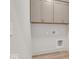 Laundry room with upper cabinets and vinyl flooring at 675 E 16Th St, Indianapolis, IN 46202
