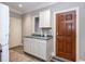 Basement laundry room features white cabinets, sink, and a separate entrance at 4499 W 131St St, Carmel, IN 46074