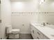 Clean bathroom with single vanity, toilet, and grey tile floor at 810 7Th St, Columbus, IN 47201
