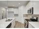 Modern kitchen with white cabinets, quartz countertops, and stainless steel appliances at 5715 Cr W 750 N, McCordsville, IN 46055