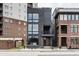 Modern three-story home with dark brick exterior and large windows at 501 S East St, Indianapolis, IN 46225