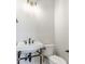 Classic bathroom with pedestal sink, toilet, and brass fixtures at 505 S East St, Indianapolis, IN 46203