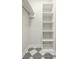Closet with white shelves and hanging rod, geometric tile floor at 505 S East St, Indianapolis, IN 46203