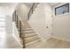Modern staircase with metal railing and light wood steps at 505 S East St, Indianapolis, IN 46203