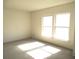 Well-lit bedroom with carpet flooring and large windows at 5824 Skyward Ln, Indianapolis, IN 46234