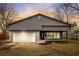Newly renovated gray house with white garage door and landscaping at 6233 Lafayette Rd, Indianapolis, IN 46278