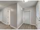 Bright hallway with grey walls and wood-look floors at 6233 Lafayette Rd, Indianapolis, IN 46278