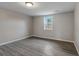 Spacious bedroom with grey walls and wood-look floors at 6233 Lafayette Rd, Indianapolis, IN 46278