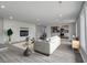 Living room with fireplace, hardwood floors and open concept to kitchen at 6233 Lafayette Rd, Indianapolis, IN 46278