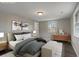 Virtually staged bedroom with wood-look floors and large windows at 6233 Lafayette Rd, Indianapolis, IN 46278