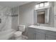 Modern bathroom with grey vanity and marble tile shower at 6233 Lafayette Rd, Indianapolis, IN 46278