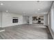 Living room with fireplace and hardwood floors, open to kitchen at 6233 Lafayette Rd, Indianapolis, IN 46278