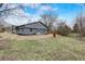 Newly renovated ranch house exterior boasts gray siding, landscaped yard, and a spacious backyard at 6233 Lafayette Rd, Indianapolis, IN 46278