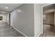 Bright hallway with grey walls and wood-look floors at 6233 Lafayette Rd, Indianapolis, IN 46278